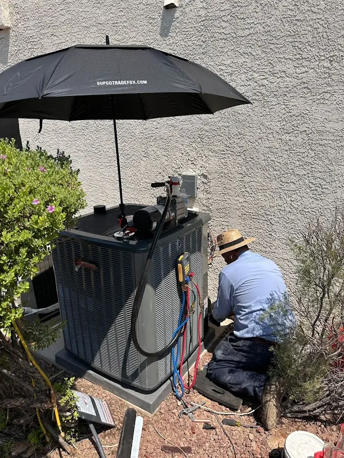 HVAC technician performing outdoor AC maintenance in New Brighton